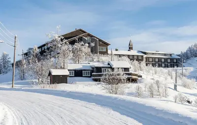 a lodge in the snow with a road in front at 2 Bedroom Lovely Apartment In Rjukan in Rjukan
