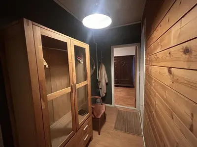 a hallway with a wooden cabinet and a light at City apartment in Bergen in Bergen