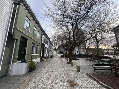 a cobblestone street in front of a building at City apartment in Bergen in Bergen