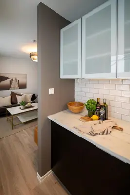 a kitchen with white cabinets and a counter top at Ultra central flat with balcony in Bergen