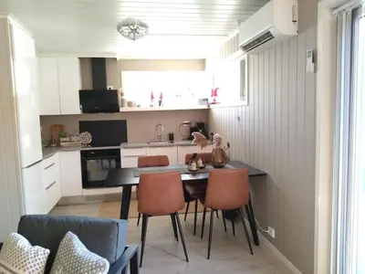 a small kitchen with a dining table and chairs at Holiday home near all facilities in Grinde, Aksdal in Tysvær