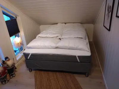 a bed with white pillows on it in a room at Holiday home near all facilities in Grinde, Aksdal in Tysvær