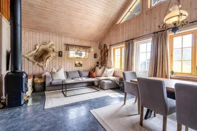 a living room with a couch and a stove at Cozy ski in&out cabin Hemsedal in Hemsedal