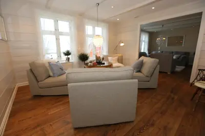 a living room with two couches and a table at Alnes Gård in Ålesund