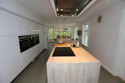 a large kitchen with a large wooden island in the middle at Alnes Gård in Ålesund