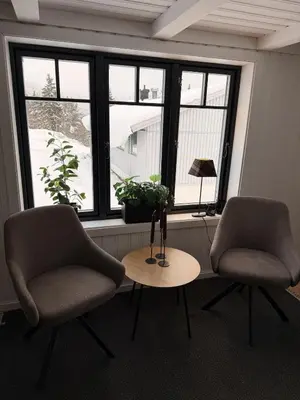 two chairs and a table in front of a window at Quiet detached house in Haukeli, modern and homey in Haukeligrend
