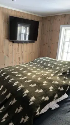a bedroom with a black and white blanket on a bed at Quiet detached house in Haukeli, modern and homey in Haukeligrend