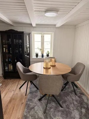 a dining room with a wooden table and chairs at Quiet detached house in Haukeli, modern and homey in Haukeligrend