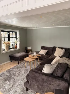 a living room with a couch and a table at Quiet detached house in Haukeli, modern and homey in Haukeligrend