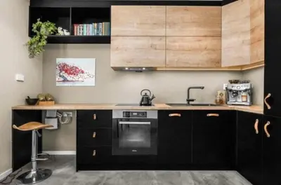 a kitchen with black cabinets and a sink at House 2 rooms in Trondheim