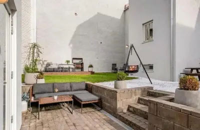 a patio with a couch and a fire pit at House 2 rooms in Trondheim