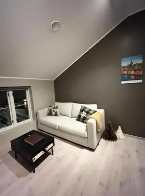 a living room with a white couch and a table at House 2 rooms in Trondheim