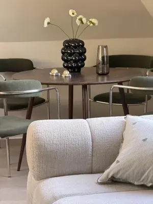 a living room with a couch and a table with chairs at Cozy loft apartment in the heart of Bergen in Bergen