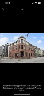 a large brick building on the side of a street at Great apartment in the center of Ålesund in Ålesund