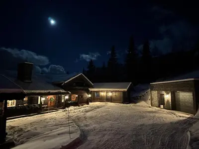 a house in the snow at night with the moon at Skogstad Lodge, Hemsedal in Hemsedal