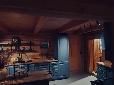 a kitchen with blue cabinets and a wooden wall at Skogstad Lodge, Hemsedal in Hemsedal