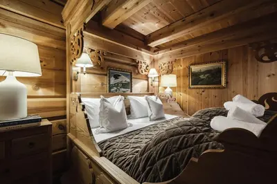 a bedroom with a large bed in a wooden room at Skogstad Lodge, Hemsedal in Hemsedal