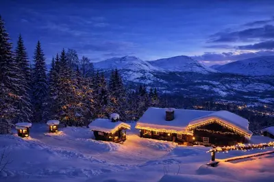 a house covered in snow at night with lights at Skogstad Lodge, Hemsedal in Hemsedal