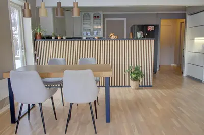 a dining room table and chairs in a kitchen at Central apartment with parking in unique surroundings in Bergen
