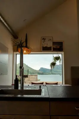 a kitchen with a sink and a large window at Large house with Ocean view at Ervik and Vestkapp