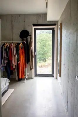 a hallway with a door and a closet with clothes at Large house with Ocean view at Ervik and Vestkapp