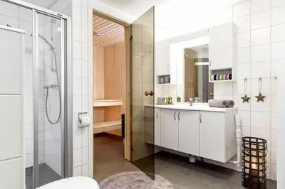 a bathroom with a shower and a sink and a mirror at Skarsnuten Panorama 61, Hemsedal in Hemsedal