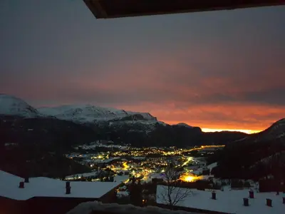 a view of a town in the snow at sunset at Skarsnuten Panorama 61, Hemsedal in Hemsedal