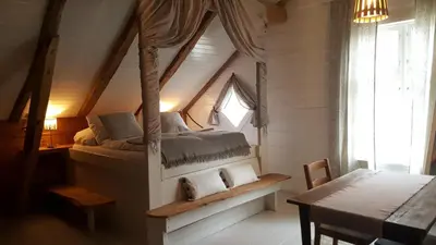 a bedroom with a bed in a attic at Rødseter Gjestegård in Fjarland