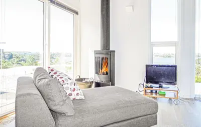 a living room with a couch and a fireplace at Beautiful Home In Fitjar in Fitjar