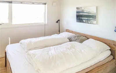 two white beds in a room with a window at Beautiful Home In Fitjar in Fitjar