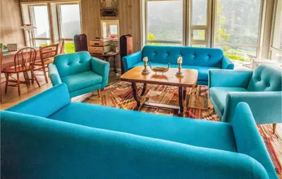 a living room with blue couches and a table at 4 Bedroom Stunning Home In Skjolden in Skjolden