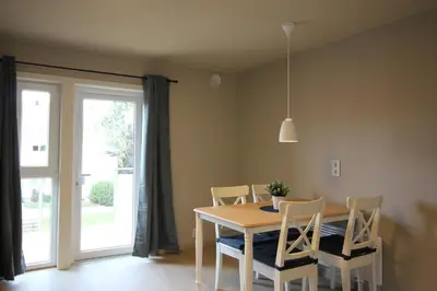a dining room with a table and chairs and a window at Setnes Feriesenter in Veblungsnes