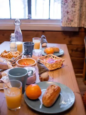 a table topped with plates of food and orange juice at Sjodalen Hyttetun og Camping in Stuttgongfossen