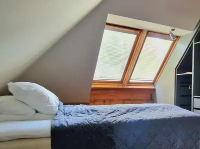 a bedroom with a bed and a window at Amunds Apartment in Bergen