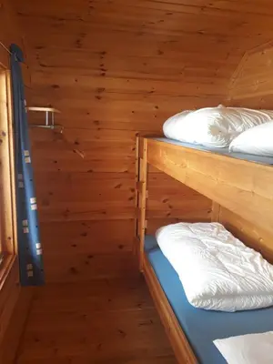 a room with two bunk beds in a cabin at Dalen Gaard camping og hytter in Geiranger