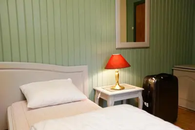 a bedroom with two beds and a lamp and a suitcase at Frya Leir in Frya