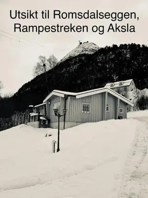 a building in the snow with the wordsushka ill russianlezlezromy at Villa Haudalan Åndalsnes in Åndalsnes