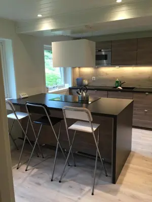 a kitchen with a table and chairs in a room at Villa Haudalan Åndalsnes in Åndalsnes