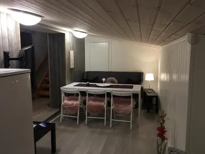 a room with a table and chairs in a room at Kvamseter Lodge in Kvamseter