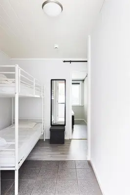 a room with two bunk beds and a mirror at Trolltunga Aparthotel in Tysso