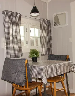 a dining room with a table and two chairs at Sandli Overnatting in Alvdal