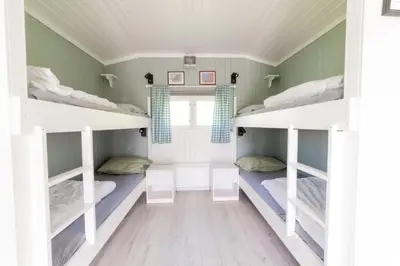 a room with three bunk beds in it at Sandli Overnatting in Alvdal
