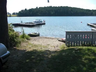 a couple of boats docked at a dock on a lake at Steinvik Camping in Moelv