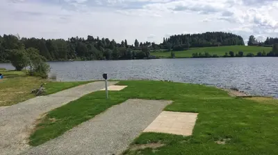 a path next to a body of water at Steinvik Camping in Moelv