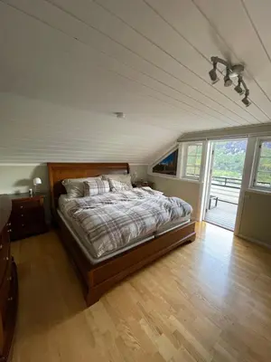 a bedroom with a bed and a large window at Aarnes house Stryn in Stryn
