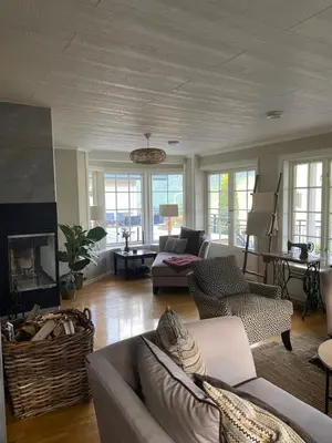 a living room with a couch and a fireplace at Aarnes house Stryn in Stryn