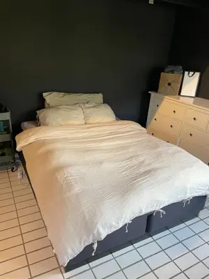 a bedroom with a bed with a white comforter at Aarnes house Stryn in Stryn