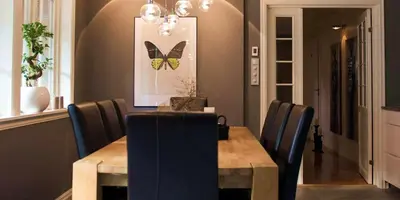 a dining room with a wooden table and a butterfly picture at Aarnes house Stryn in Stryn