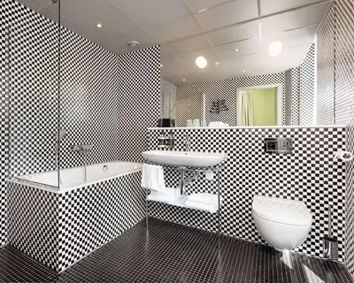 a bathroom with a sink and a toilet and a tub at Grand Hotel Terminus in Bergen