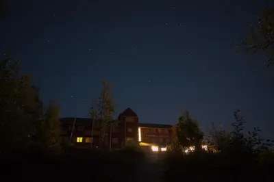 a building at night with the stars in the sky at Fossli Hotel in Eidfjord